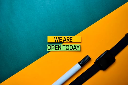 We Are Open Today text on top view color table background. photo