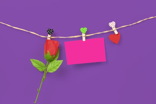 Handmade wood hearts hanging on cloth line and rose flower photo