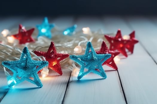 Christmas background with blue light luminous garlands and red stars on a white wooden background with copy space. photo
