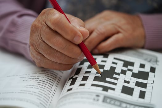 Asian elderly woman playing sudoku puzzle game to practice brain training for dementia prevention, Alzheimer disease. photo
