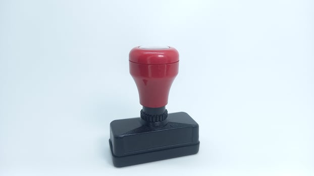 a red rubber stamp on a white background photo