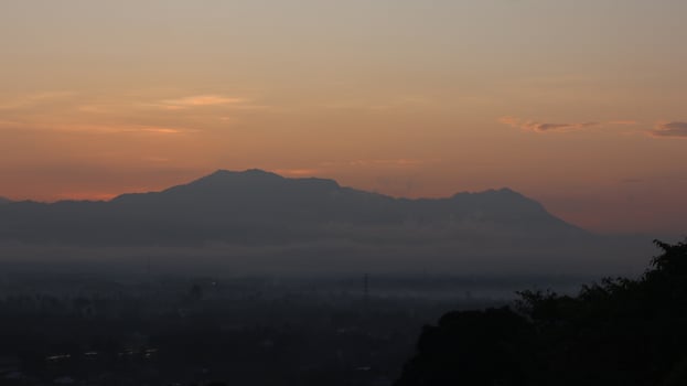 The sun rises over the mountains photo