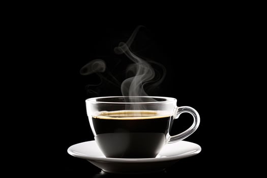 Close up a cup of a black hot coffee with smoke on black background. photo