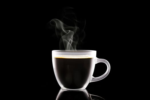 Close up a cup of a black hot coffee with smoke on black background. photo