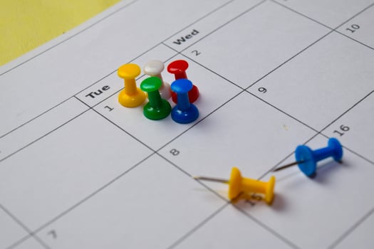 Close up Pinboard on white calendar. Schedule, reminder concept photo