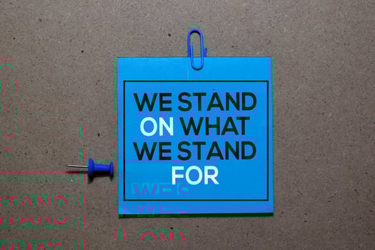 We Stand On What We Stand For write on sticky notes isolated on Office Desk photo