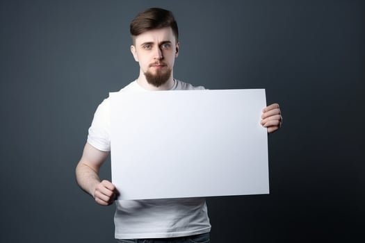 A man holds a blank white sign board mockup in his hand photo