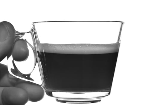 Cup of espresso coffee in hand against white background photo