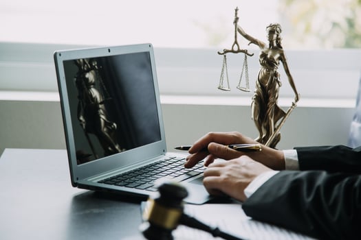 Business and lawyers discussing contract papers with brass scale on desk in office. Law, legal services, advice, justice and law concept picture with film grain effect photo