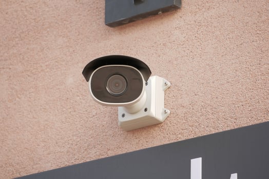CCTV security camera operating on wall photo