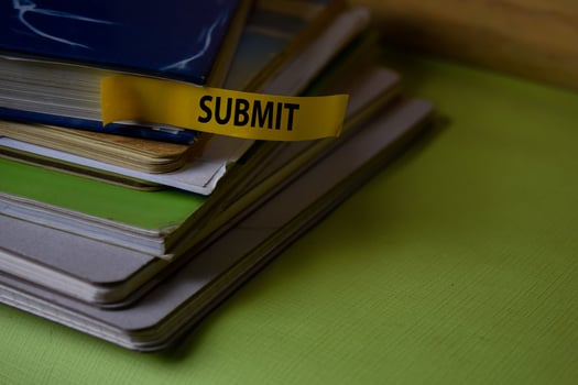 Submit write on a sticky note isolated on Office Desk. Business Document concept photo
