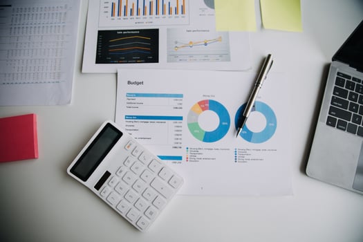 Financial analysts analyze business financial reports on a digital tablet planning investment project during a discussion at a meeting of corporate showing the results of their successful teamwork. photo
