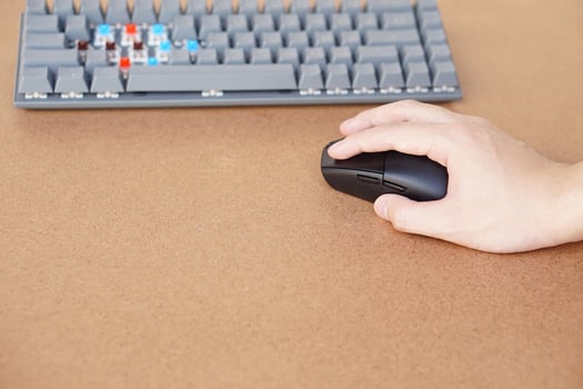 Hand hold wireless mouse with keyboard computer. Concept working on computer,  surfing internet, online business, play computer games or  entertainment. Technology device in dailylife. photo