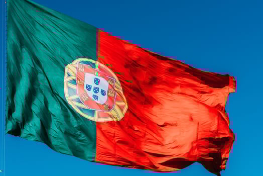 Portugal flag isolated on the blue sky waving in the wind photo