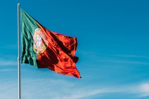 Portugal flag isolated on the blue sky waving in the wind photo