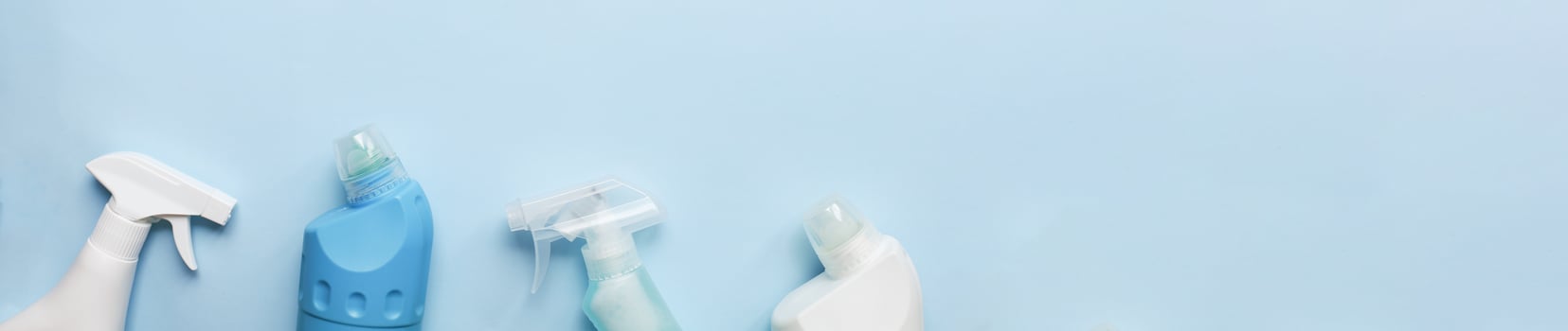 Banner Cleaning tool mockup. Flat lay cleaning products on a blue background. Sprays and bottles for cleaning photo
