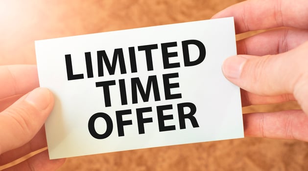 LIMITED TIME OFFER word inscription on white card paper sheet in hands of a businessman. recap concept. red and white paper photo