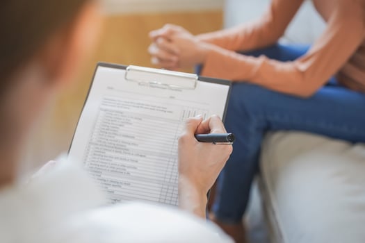 Psychology, depression. Sad, suffering asian young woman consulting with psychologist, psychiatrist while patient counseling mental with doctor woman taking notes at clinic. Encouraging, therapy. photo