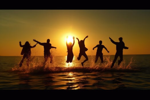 Young group of people jumping into the air at beach. photo