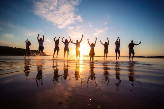 Young group of people jumping into the air at beach. photo