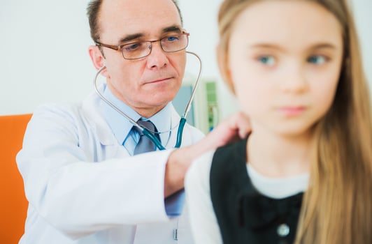 Doctor Examining Little Girl photo