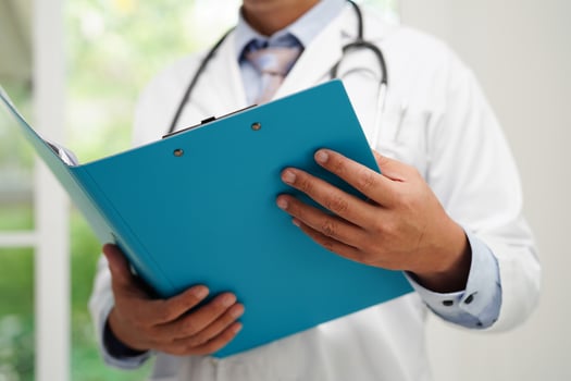 Asian man doctor study document to research method and technic for treating patients. photo