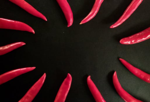 Fresh red chili on a black background as a background. photo