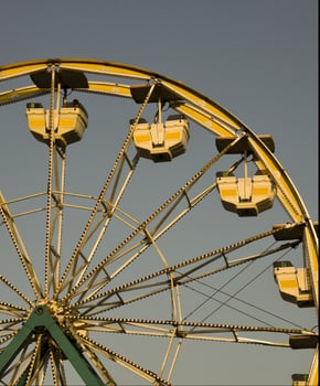 Ferris wheel against blue cloudy sky on sunny weather photo