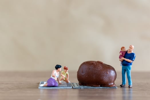 Miniature people Happy family enjoying chocolate photo
