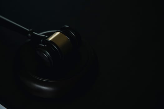 Business and lawyers discussing contract papers with brass scale on desk in office. Law, legal services, advice, justice and law concept picture with film grain effect photo