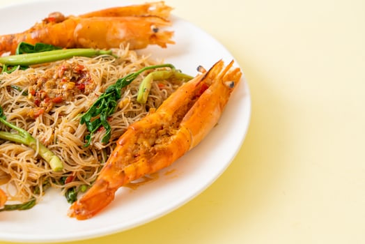 Stir-fried rice vermicelli and water mimosa with river prawns photo