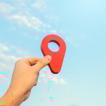Set location. Red geolocation pin icon in hand. Land market. Tourism and travel. Navigate a route. Location announcement. Gathering place. Business advertising. Transport services. photo
