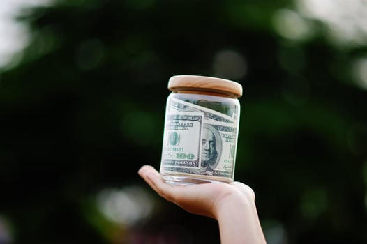 dollar bills in glass bottles Saving money in a glass jar, earnings, income, expenses, profits, financial success financial security photo