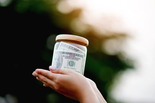 dollar bills in glass bottles Saving money in a glass jar, earnings, income, expenses, profits, financial success financial security photo