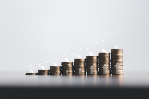 Stacked coins on wooden table with white illustration shows increasing of interest rates, financial concept. Interest rate financial and mortgage rates. Icon percentage symbol and arrow pointing up. photo