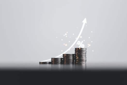 Stacked coins on wooden table with white illustration shows increasing of interest rates, financial concept. Interest rate financial and mortgage rates. Icon percentage symbol and arrow pointing up. photo
