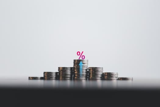 Stacked coins on wooden table with illustration shows increasing of interest rates, financial concept. Interest rate financial and mortgage rates. Icon percentage symbol and arrow pointing up. photo