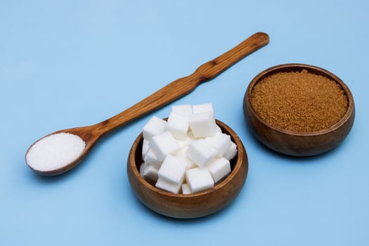 cane and beet sugar and refined sugar in a wooden bowl photo