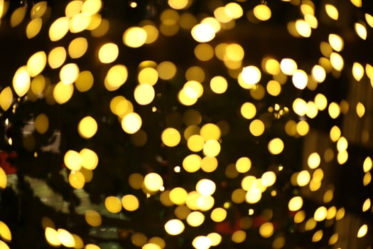 blur bokeh circus tube lamp hang from ceiling in dark room like firefly photo