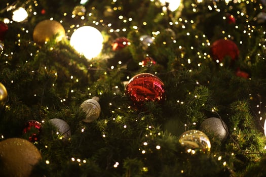 close up decoration ball and light bulb on christmas tree at night photo