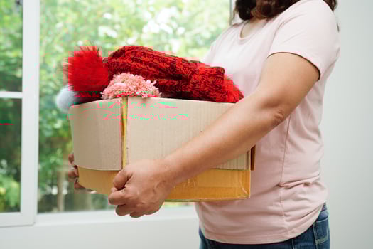 Clothes donations in cardboard box for volunteer. photo