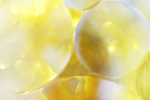 Gold Oil bubbles close up. circles of water macro. abstract shiny yellow background photo