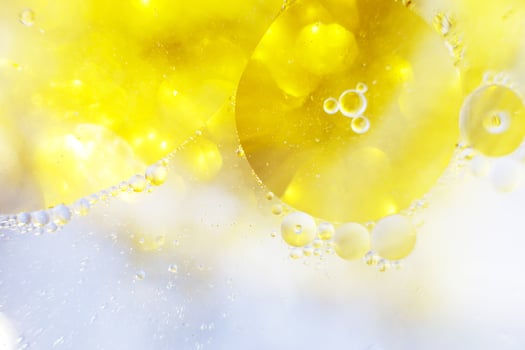 Gold Oil bubbles close up. circles of water macro. abstract shiny yellow background photo