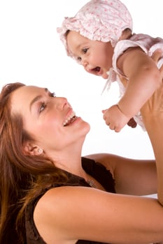 Happy beautiful young mother and her baby girl on white background photo
