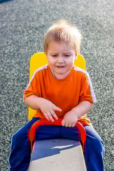 Portrait of a boy. A child is playing on the Playground. Riding on the swings. Happy child. photo
