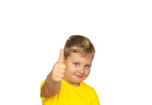 A boy in a yellow T-shirt on a white background points his fingers at a positive rating. Like. The concept of a banner with information. Space for the text. photo