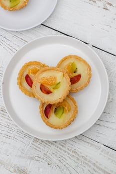 Small fruit pia cake on a textured white background. Kue Pia Buah. photo