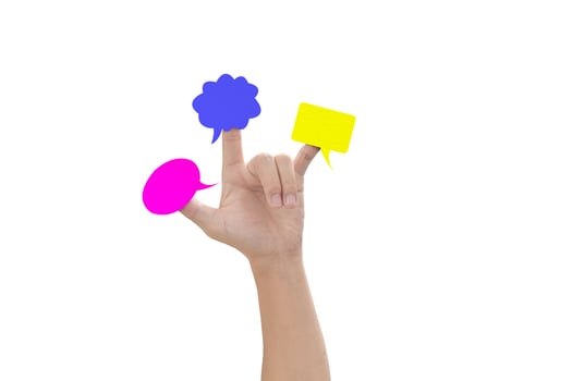 Multicolor speech bubbles on child hand fingers isolated on white background, with clipping path. photo