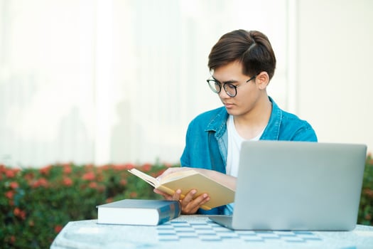 Student studying outdoor using laptop. photo