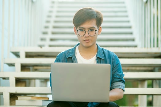 Student studying outdoor using laptop. photo